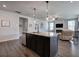 Open-concept kitchen with island and living area featuring a cozy fireplace at 34 Mountainbrook Nw Dr, Cartersville, GA 30121