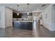 Open-concept kitchen with dark cabinets, a granite island, stainless steel appliances, and hardwood floors at 34 Mountainbrook Nw Dr, Cartersville, GA 30121
