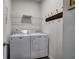 Laundry room with white washer and dryer, wire shelf, and gray walls at 34 Mountainbrook Nw Dr, Cartersville, GA 30121