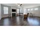 Bright living room with a fireplace, a ceiling fan, and an adjacent dining area providing comfortable space at 34 Mountainbrook Nw Dr, Cartersville, GA 30121