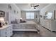 Bright main bedroom features patterned bedding, neutral walls, white trim, carpet, and ceiling fan at 34 Mountainbrook Nw Dr, Cartersville, GA 30121