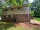Exterior view of home with a mix of brick and vinyl, with access to the backyard and surrounding nature at 4135 Moore Rd, Conley, GA 30288