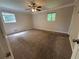 Spacious bedroom with neutral carpet, ample natural light from two windows, and a ceiling fan for comfort at 4135 Moore Rd, Conley, GA 30288