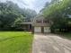 Charming two-story home featuring a brick and vinyl facade, a two-car garage, and a well-manicured front lawn at 4135 Moore Rd, Conley, GA 30288