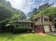 Charming brick and vinyl home with a two-car garage, steps to the front door, and a lush green lawn under a partly cloudy sky at 4135 Moore Rd, Conley, GA 30288