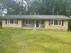 Single-story home with a well-maintained lawn and inviting curb appeal at 4734 Lawrenceville Hwy, Tucker, GA 30084