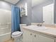 Hall bathroom features a shower over bath, sink with vanity, and blue shower curtain at 855 Cedar Bluff Ct, Marietta, GA 30062