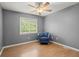 Bright bedroom features wood floors, accent chair, ceiling fan, and a window at 855 Cedar Bluff Ct, Marietta, GA 30062