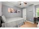 Cozy bedroom has a single bed, wood floors, ceiling fan, and large window at 855 Cedar Bluff Ct, Marietta, GA 30062