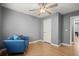 This bedroom features grey walls, a ceiling fan, a door, a radiator, and wood-look floors at 855 Cedar Bluff Ct, Marietta, GA 30062