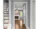 Entryway with hardwood floors leads to a living room and staircase with white risers and a gray frame at 855 Cedar Bluff Ct, Marietta, GA 30062