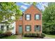 Charming brick front home with a manicured lawn, lush greenery and complemented by dark shutters at 855 Cedar Bluff Ct, Marietta, GA 30062