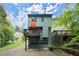 Charming multi-story home with a backyard deck and garage, surrounded by lush greenery at 855 Cedar Bluff Ct, Marietta, GA 30062