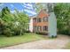 Brick home with dark shutters and a lush green lawn and garden in a serene neighborhood setting at 855 Cedar Bluff Ct, Marietta, GA 30062