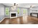 Bright living room with hardwood floors, fireplace, a ceiling fan, and access to a patio with lovely natural light at 855 Cedar Bluff Ct, Marietta, GA 30062