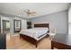 Spacious main bedroom has wood floors, ceiling fan, windows and a large bed at 855 Cedar Bluff Ct, Marietta, GA 30062