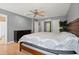 Spacious main bedroom has wood floors, ceiling fan, windows and a large bed at 855 Cedar Bluff Ct, Marietta, GA 30062