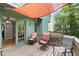 This patio features outdoor furniture, privacy shade, and views of the lush green yard at 855 Cedar Bluff Ct, Marietta, GA 30062