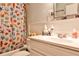 Clean bathroom with a seashell shower curtain, white vanity, and classic fixtures at 1111 Clairemont Ave # 5, Decatur, GA 30030