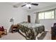 Comfortable bedroom with a patterned comforter, ceiling fan, and neutral walls at 1111 Clairemont Ave # 5, Decatur, GA 30030