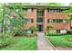 Charming brick apartment building with mature landscaping and well-maintained front lawn at 1111 Clairemont Ave # 5, Decatur, GA 30030