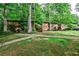 Well-maintained apartment complex surrounded by lush green trees and a neatly manicured lawn at 1111 Clairemont Ave # 5, Decatur, GA 30030