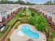 Aerial view of community pool, playground, landscaping, and townhome exteriors at 1327 Rosen Rd, Brookhaven, GA 30319