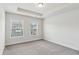 Bedroom with a neutral color palette, carpeted floors and two large windows at 1327 Rosen Rd, Brookhaven, GA 30319