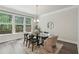 Bright dining area with modern table set, decorative lighting, and large windows overlooking the backyard at 1327 Rosen Rd, Brookhaven, GA 30319