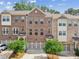 Charming brick townhome featuring a two-car garage and well-maintained landscaping at 1327 Rosen Rd, Brookhaven, GA 30319