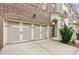 Close up of the two-car garage and entrance of a brick townhome at 1327 Rosen Rd, Brookhaven, GA 30319