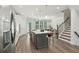 Spacious kitchen with island, stainless appliances, and open layout to dining and staircase at 1327 Rosen Rd, Brookhaven, GA 30319