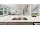 Close up of a luxurious kitchen island with quartz countertops, stainless steel sink, and breakfast bar at 1327 Rosen Rd, Brookhaven, GA 30319