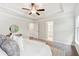 Large main bedroom with a tray ceiling and open doorways to the main bathroom and closet at 1327 Rosen Rd, Brookhaven, GA 30319