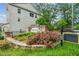 Attractive stone entry sign for Evins Walk amid colorful plantings and manicured landscaping at 1327 Rosen Rd, Brookhaven, GA 30319