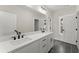 Elegant bathroom with a double sink vanity, featuring sleek black hardware and a large mirror at 1419 Coretta Bnd, Atlanta, GA 30318