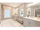 Modern bathroom with double vanity, soaking tub, and a neutral color palette at 1419 Coretta Bnd, Atlanta, GA 30318