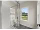 Bright bathroom showcases a glass-enclosed shower, white subway tile, and a window offering a lovely outdoor view at 1419 Coretta Bnd, Atlanta, GA 30318