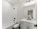 Modern bathroom with white subway tile, dark fixtures, and white vanity at 1419 Coretta Bnd, Atlanta, GA 30318