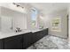 Bathroom featuring dual vanities, modern fixtures, and a sleek design with marble-look flooring at 1419 Coretta Bnd, Atlanta, GA 30318