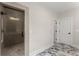 Bright bathroom features a glass shower with tiled walls and a stylish marble patterned tile floor at 1419 Coretta Bnd, Atlanta, GA 30318