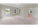 Large carpeted bedroom with light walls, large windows and view to bathroom at 1419 Coretta Bnd, Atlanta, GA 30318