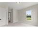 Bright bedroom with neutral carpet, a window and features a closet door on the right at 1419 Coretta Bnd, Atlanta, GA 30318