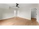 Bedroom featuring hardwood flooring, ample natural light, and access to an organized walk-in closet at 1419 Coretta Bnd, Atlanta, GA 30318