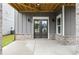 Covered entryway features double doors, gray siding, and brick foundation at 1419 Coretta Bnd, Atlanta, GA 30318