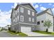 Three-story home with two-car garage and an attractive, well-maintained lawn at 1419 Coretta Bnd, Atlanta, GA 30318