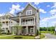 Attractive home featuring a covered porch, gray siding, and manicured landscaping at 1419 Coretta Bnd, Atlanta, GA 30318