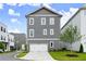Charming home with gray siding, white trim, a well-manicured lawn, and an attached two-car garage at 1419 Coretta Bnd, Atlanta, GA 30318
