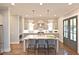 Modern kitchen featuring an island, stainless steel appliances, pendant lighting, and hardwood floors at 1419 Coretta Bnd, Atlanta, GA 30318