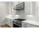 Kitchen details include stainless steel appliances, quartz counters and white subway tile backsplash at 1419 Coretta Bnd, Atlanta, GA 30318